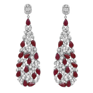 An image of a pair of Rachel Koen women's earrings featuring sparkling diamonds and rich red ruby gemstones. The earrings are displayed in a front-facing view at a close distance, showing the intricate design of teardrop-shaped gemstones nested within halos of round brilliant-cut diamonds, creating an elegant cascading effect. The earrings hang vertically, showcasing their full length and the symmetrical arrangement of stones in white gold metal.
