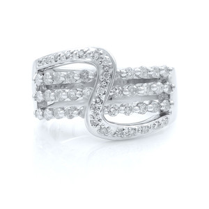 An image of a Rachel Koen women's ring with diamonds set on a white gold band, displayed front and center. The ring features a unique band design with multiple diamond-encrusted loops interlocking at different angles, creating a sense of movement and elegance. The photograph is taken from a top-down perspective, showcasing the glittering stones and the intricate details of the setting, all against a white background for contrast.