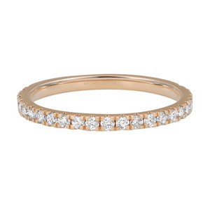 An image of a Rachel Koen women's ring with lab grown diamonds, showcasing a side view at a slight angle. The ring, featuring a continuous band of sparkling lab grown diamonds set in a prong setting, is centered in the frame against a white background, providing a clear view of its detailed craftsmanship and the reflective quality of the stones. The yellow gold band is visible with a stamped hallmark indicating 14K gold, and the diamonds are arranged closely together, encircling the entire band. The image is taken from a medium distance, allowing the entire ring to be in focus while highlighting the intricate design and luxurious appearance of the jewelry.