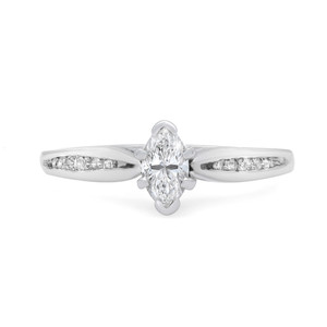 An image of a Rachel Koen women's engagement ring with diamonds, featuring a marquise-cut central diamond set in a prong setting with smaller round-cut diamonds channel-set along the band. The ring is positioned centrally, facing forward at a slight angle that showcases the top and side profile, with the focus on the central stone. The distance is close enough to capture the brilliance of the diamonds and the polished white gold finish of the band.