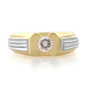 An image of a men's Rachel Koen ring with diamond, shown in a frontal view. The ring features a prominent central diamond set in a hexagonal bezel on a polished yellow gold band. Flanking the diamond are sections with white gold ridged details, giving the piece a contrasting two-tone appearance. The ring is displayed against a white background with a soft shadow beneath, indicating it is photographed from a slightly elevated angle at close distance for a clear view of the diamond and design details. The ring is pre-owned in a great condition. 