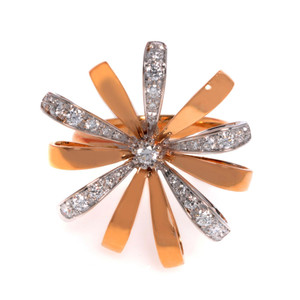An image of a Luca Carati women's cocktail ring with diamonds, displayed against a white background. The ring features a unique flower-like design with multiple rose and white gold petals extending radially. Each petal is partially encrusted with small, sparkling diamonds, converging toward a larger central diamond. The ring is photographed from a top-down perspective, providing a clear view of the intricate detailing and the play of light on the gemstones. The close-up shot ensures the ring fills the frame, highlighting its luxurious and elegant appearance.