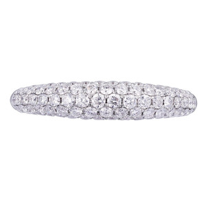 An image of a Rachel Koen brand women's wedding ring with diamonds, showcased in a close-up, top-down view. The ring is centrally positioned and fills the frame, displaying multiple rows of sparkling diamonds set in a band with a bright, white gold finish. The diamonds are arranged in a pave setting, creating a continuous glittering surface across the entire visible part of the ring. The image is taken from a distance close enough to reveal the intricate details and cut of each diamond.