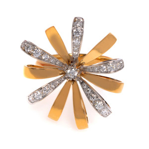 An image of a new Luca Carati women's cocktail ring with diamonds, displayed at a close-up, top-down angle. The ring features a flower design with multiple elongated yellow gold petals radiating from the center with alternating white gold petal studded with round cut diamonds, enhancing the ring's elegance. In the core, there is a larger, prominent diamond surrounded by a halo of smaller stones, positioned to catch the light from various angles. The white background emphasizes the ring's luster and intricate details.