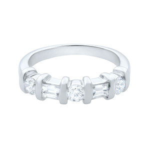 An image of a Rachel Koen women's ring with diamonds, showcased in a straight-on frontal view against a white background. The ring features a polished, white gold band with a series of round and emerald cut diamonds securely held in place by sleek, vertical bar settings. The diamonds are evenly spaced, creating a symmetrical and elegant appearance. The image is taken from a close distance, providing a clear view of the ring's design and the sparkling facets of the diamonds.
