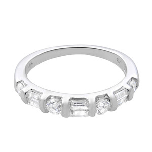 An image of a Rachel Koen women's wedding ring with diamonds, displayed in close-up frontal view. The ring is positioned horizontally across the center of the frame, showcasing a polished white gold band with a series of round and baguette diamonds set in a symmetrical pattern along the top half. The diamonds catch the light, highlighting their clarity and cut, while the smooth band reflects a bright sheen indicative of a high-quality finish. The ring is pre owned in a great condition. 