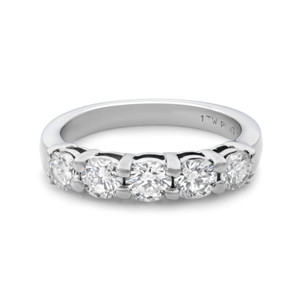 An image of a Rachel Koen brand women's wedding ring with diamonds, viewed from a top angle showcasing the diamonds set in the band. The ring is positioned centrally in the frame with a close-up view, allowing for clear visibility of the individual diamonds and their settings. The platinum band has a polished finish and the diamonds are round cut, evenly spaced in a shared prong setting along the top half of the ring. The background is white, emphasizing the ring's details. The ring is pre-owned in great condition. 