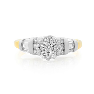 An image of a Rachel Koen women's wedding ring with diamonds, displayed front and center on a white background. The ring features a cluster of round brilliant-cut diamonds set in white gold at the top, flanked by baguette-cut diamond accents on a yellow gold band. The view is a close-up, capturing the ring's details and the light reflecting off the diamonds from a top-down angle.