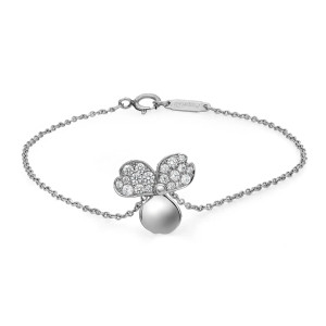 An image of a women's Tiffany & Co. bracelet with diamonds displayed in a close-up, frontal view. The bracelet features a delicate platinum chain and a centerpiece designed as a three leaves clover adorned with small, sparkling diamonds on two petals. The bracelet is positioned against a white background, highlighting its elegance and intricate details.