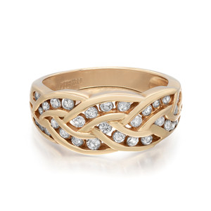 An image of a Rachel Koen women's ring with diamonds, displayed in a close-up view against a white background. The ring features a yellow gold band with an intricate, interwoven design. Sparkling round cut diamonds are set within the overlaps of the band, catching the light at various angles. The photo is taken from a top-down perspective, showcasing the full circle of the band and the detailed craftsmanship of the setting. The distance is close enough to reveal the ring's texture and the brilliance of the diamonds clearly. The ring is pre owned in a great condition. 