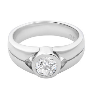 An image of a unisex adult engagement ring by Rachel Koen, showcased in a close-up front view. The ring is designed with a thick, polished platinum band that tapers towards the center, where a large, round brilliant-cut diamond is bezel set. The diamond is positioned flush with the band, creating a seamless and modern appearance. The lighting reflects off the smooth metal and facets of the diamond, highlighting its clarity and craftsmanship. The ring's interior is slightly visible, revealing the brand's hallmark.The ring is pre-owned in a great condition. 