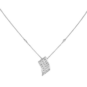 An image of a Luca Carati women's necklace with diamonds, featuring a pendant with three rows of channel-set diamonds hanging centrally on a fine white gold chain. The pendant is displayed at a direct frontal angle against a white background, with the chain partially visible extending to the upper corners of the image, suggesting a medium distance perspective. The necklace is positioned in a way that the pendant is the clear focal point, illustrating its design and the sparkle of the diamonds. The necklace comes in excellent preowned condition.