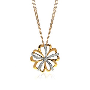 An image of new Luca Carati women's necklace with diamonds, featuring a floral pendant design with alternating yellow and white gold diamond-encrusted petals. The pendant is centered and shown at a front-facing angle with a slight elevation, allowing a full view of the design. It is suspended from a delicate yellow gold chain that appears at the top corners of the frame, giving a sense of its length. The background is white, emphasizing the jewelry's luster, and there is a subtle reflection below the pendant indicating a shiny surface.