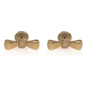 An image of a pair of Luca Carati women's earrings with diamonds, displayed frontally at a medium distance. The earrings feature a yellow gold bow design with a cluster of small round cut diamonds set in the center, capturing light from a frontal angle. The background is plain and white, emphasizing the jewelry's details.