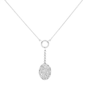 An image of a Piero Milano necklace designed for women, featuring diamonds. The necklace is displayed against a white background with a front-facing view. It showcases a delicate white gold chain with a central circular diamond-encrusted circle from which a vertical row of graduated diamonds leads to an oval-shaped diamond pendant in white gold. The image is taken from a medium distance, providing a clear view of the necklace's design and details without any noticeable distortion from angles.