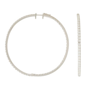 An image of a Rachel Koen brand earring designed for women, showcasing a large inside out a diamond hoop earrings crafted in a white gold. The earring is photographed from two different angles; one hoop is viewed frontally, forming a complete circle with its clasp slightly open, while the second hoop is seen from the side, displaying a line of diamonds set along its edge. Both earrings are positioned against a white background, with the frontal view on the left and the side view on the right, providing a clear perspective of the earring's design and diamond encrustation. The image is taken from a close distance to highlight the details of the diamonds and the overall craftsmanship.
