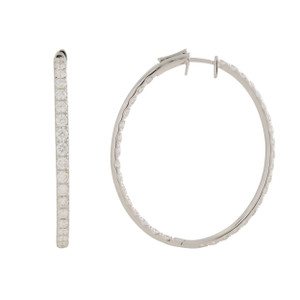 An image of a Rachel Koen brand oval hoop white gold earring for women, featuring diamonds. The earring is presented against a white background, with one hoop standing upright showcasing the outer edge and the other lying flat, displaying the diamond-encrusted inner surface. The upright hoop is viewed from a side angle, while the flat hoop gives a clear top-down view, illustrating the sparkle and distribution of diamonds along its circumference. The distance between the camera and the earring is close enough to capture the intricate details and the reflective quality of the diamonds.