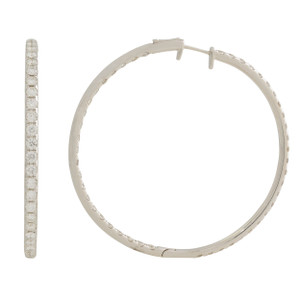 An image of a Rachel Koen brand women's medium hoop earring with inside out diamonds set in a white gold, displayed against a white background. The earring is shown in two different angles: one side view on the left, highlighting a row of diamonds set along the earring's outer edge, and a frontal view on the right showing the hoop's circular shape and the latch mechanism. The earring appears to be a medium hoop design, and the diamonds are visible along the forward-facing side, suggesting a luxurious and sparkling appearance. The distance between the earring views suggests a close-up perspective to emphasize detail.