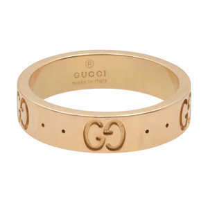 An image of a Gucci icon women's ring without stones, displayed in a frontal view against a white background. The ring is centered with the brand name "GUCCI made in Italy" engraved inside. The trademarked Gucci "GG" logo is patterned around the exterior circumference, interspaced with small circular indentations. The polished rose gold finish reflects light, highlighting the smooth surface and the iconic branding. The perspective is head-on, ensuring the entire circumference is visible and the ring appears to be at a medium distance from the viewer. The ring is pre owned in a great condition. 