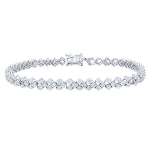 An image of a Rachel Koen women's triangle motif tennis white gold bracelet with round cut diamonds, displayed on a neutral background. The bracelet is laid out straight with the clasp on the right side, positioned centrally and viewed from a top-down angle, showcasing the full length and detail of the piece. The diamonds catch the light, emphasizing their cut and brilliance, and the bracelet appears at a close distance allowing for clear visibility of its design and features.