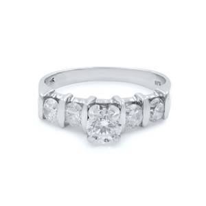 An image of a Rachel Koen brand women's engagement ring with diamonds. The ring is displayed in a close-up view on a white background. It features a central round-cut diamond in a prong setting, flanked by smaller round diamonds on either side, also in prong settings. The band is made of polished white gold. The angle of the photo is a front-facing view that slightly tilts upward, showcasing the sparkle and detail of the diamonds and the setting.
