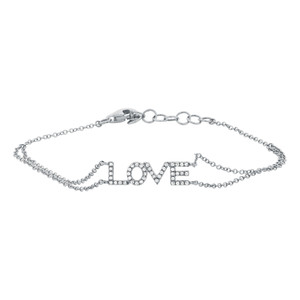 An image of a Rachel Koen women's bracelet with diamonds, displayed against a white background. The bracelet features the word "LOVE" in capital letters, with each letter encrusted with diamonds and connected by a delicate chain. The view is a close-up, taken from a top-down angle, centered, and shows the bracelet laid out in a slight curve with the clasp visible to the left side, demonstrating the design and craftsmanship of the piece.