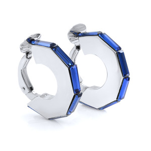 An image of a Dior women's clip on hoop earring adorned with vibrant blue crystal. The earring is displayed at a slight angle, showcasing its octagonal shape and the elegant arrangement of gemstones along the edges. The close-up view highlights the polished 925 silver and the intricate detailing of the design. Excellent pre-owned condition. 