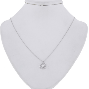 An image of a Hearts on Fire Brocade Heart single diamond women's pendant necklace, displayed on a white necklace stand. The necklace features a delicate white gold chain with a diamond-encrusted pendant at the center. The pendant is positioned at the base of the stand's neck, and the image is taken from a front-facing angle at close distance, showcasing the sparkle and design of the diamonds clearly.