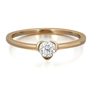 An image of a women's ring by PANDORA, featuring a sleek gold band with a single prominent round cut diamond at the center in yellow gold. The ring is positioned at a slight angle, showcasing the diamond's brilliance and the elegant setting. The image is taken from a close-up perspective, highlighting the intricate details of the design.