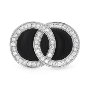 An image of a women's cocktail ring by Rachel Koen, featuring two interlocking circles encrusted with pave set round cut diamonds and black onyx gemstones. The ring is shown from a front view at a close range, highlighting the intricate design and sparkling details. The angle captures the symmetry and elegance of the overlapping circles.