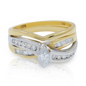 An image of an engagement ring with diamonds designed for women by Rachel Koen. The ring features a marquise-shaped diamond at the center, surrounded by a series of smaller round and baguette diamonds set into a dual-tone band of yellow and white gold. The photograph is taken from a slightly elevated angle, showcasing the intricate details and sparkle of the diamonds. The ring is positioned upright and centered in the frame, filling most of the image space, with a soft reflection visible below.