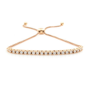 An image of a women's slider bracelet with diamonds by Rachel Koen. The bracelet is positioned horizontally with a slight upward angle, showcasing its row of sparkling 21 round brilliant cut diamonds set in a rose gold band. The adjustable chain features two ball ends, symmetrically placed in the background. The photograph is taken from a close distance, highlighting the intricate details and shine of the diamonds.