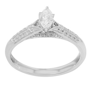 An image of an engagement white gold ring with diamonds, designed for women by Rachel Koen. The ring is positioned upright at a slight angle, showcasing a marquise-cut diamond at the center. The band is adorned with pave set round cut smaller diamonds along the sides. The image is taken from a close distance, highlighting the intricate details and sparkling features of the ring.