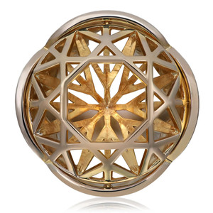 An image of a women's ring without stones by Solange Azagury, viewed from a top angle. The ring features an elaborate geometric design with interlocking patterns in yellow gold. The photograph is taken at a close distance, emphasizing the intricate details and craftsmanship of the ring's structure.