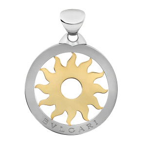 An image of a Bvlgari unisex adult pendant without stones. The design features a circular pendant with a polished outer stainless steel ring and a yellow gold sun motif at the center. The brand name "BVLGARI" is engraved at the bottom of the outer ring. The pendant is displayed from a front angle, closely centered, showcasing the intricate details of the pendant's design.