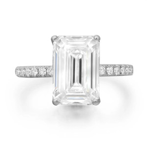 An image of an engagement ring with lab grown diamonds, featuring a large rectangular center stone set in a four-prong setting. The band is adorned with smaller round diamonds. The ring is positioned front-facing, captured at a straight angle, and shown from a close-up distance, highlighting its intricate details and sparkling surface.