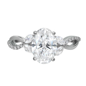 An image of an engagement ring with lab grown diamonds designed by Rachel Koen for women. The ring is displayed from the front, highlighting the large central oval diamond flanked by smaller marquise-shaped diamonds in white gold. The band features a twisted design adorned with additional small diamonds, and the angle captures the intricate detailing up close.