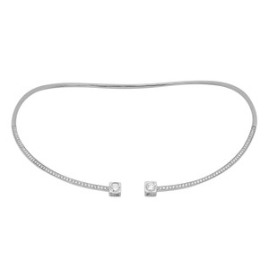 An image of a women's necklace by Dinh Van, featuring a sleek, open-ended design adorned with small diamonds along its length. The necklace is positioned horizontally against a plain white background, with a straight-on angle showing its elegant curvature. The diamonds are set in a line, leading to two larger, round shape square-set diamonds at the open ends. The image is taken at a close distance, highlighting the intricate detailing and shimmer of the diamonds. Excellent preowned condition.