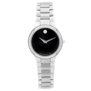 An image of a new and unworn Movado women's wristwatch in a dress/formal style, presented in a front full frontal view. It features a round stainless steel case with a steel-colored bezel adorned with diamonds The watch has a black dial with the iconic Movado dot at the 12 o'clock position and silver-tone hands. The band is made of stainless steel with a bracelet design. The watch is centered and occupies the majority of the frame, showcasing its elegant design and details clearly.