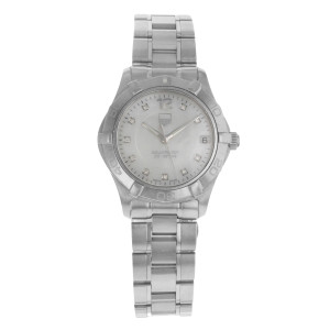 An image of a Wristwatch by TAG Heuer. This Pre Owned item is designed for Women, featuring a Classic style. It has a Quartz movement and an Analog display with a White Mother Of Pearl dial color. The indices include Diamonds. The band is made of Stainless Steel and the case is made of Stainless Steel. The watch has a Round shape with a case size of 32 mm and a case thickness of 10 mm.