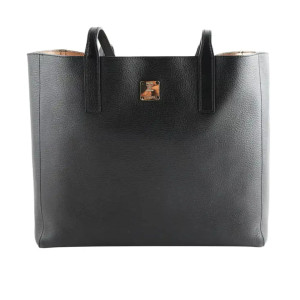 An image of a MCM Medium Black Reversible leather ladies tote shopper handbag positioned upright and centered, shown from a front angle at a close distance. The bag features two handles and a small gold-tone logo plaque on the front near the top center. The background is plain white, highlighting the handbag's smooth texture and minimalist design. The bag is pre owned in a good condition. 