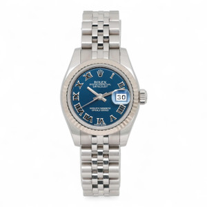 An image of a pre-owned women's Rolex Lady Datejust 26MM 18K White Gold Steel Roman Blue Dial Watch 179174 viewed from a straight-on angle. The watch features a blue dial with Roman numerals and luminous hands. The date is visible through a magnified window. The bracelet is 18k white gold with a mix of polished and brushed links. The watch is positioned centrally and up close, showcasing its details.
