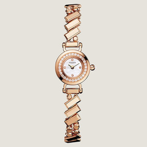 An image of a pre-owned HERMÈS  Faubourg Polka 15mm 18K Rose Gold MOP Diamond Lady's Watch W054184WW00 taken from a straight-on angle, displaying the watch face and intricate bracelet design. The watch features a round face with a mother-of-pearl dial surrounded by a diamond-encrusted bezel. The bracelet is composed of geometrically shaped links, creating a sophisticated and elegant look. The image is captured from a close distance, showcasing the luxurious details and craftsmanship of the timepiece.
