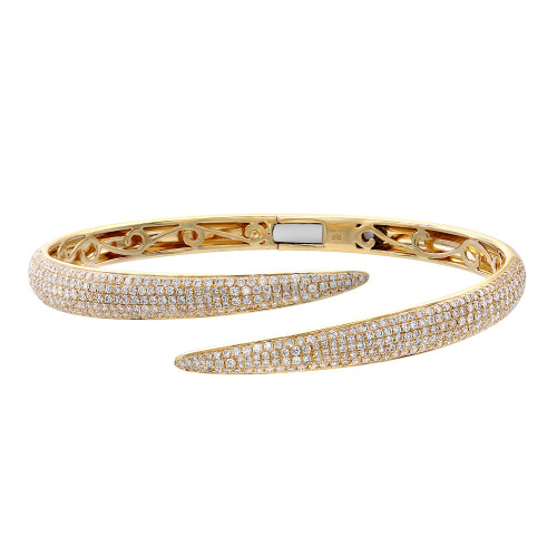 An image of a Rachel Koen women's bracelet with diamonds, showcased on a plain background. The bracelet is positioned horizontally across the center of the frame with a slight tilt, allowing a clear view of its intricate details. The perspective is a close-up, capturing the bracelet's sparkle and the fine craftsmanship of the yellow gold setting from a top-down angle. The round cut diamonds are encrusted along the top surface of the bracelet, which is open-ended with the two tips curving away from each other.