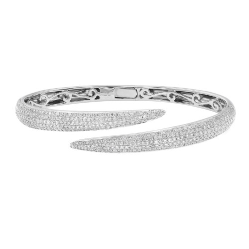 An image of a Rachel Koen women's bracelet with diamonds, showcased on a neutral background. The bracelet is positioned horizontally across the center of the frame with a slight angling to display both the top and undercarriage designs. The top view reveals an array of sparkling round cut diamonds encrusted on the surface, while the bottom view shows intricate metalwork in white gold. The bracelet is open at one end, suggesting a slip-on style, and is captured from a close, but not macro, distance allowing clear visibility of the diamonds and metal quality.