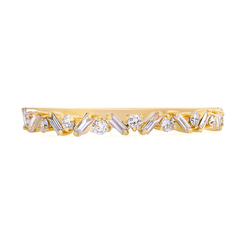 An image of a Rachel Koen women's ring with diamonds, presented in a close-up front view showcasing the entire band. The ring features a polished yellow gold band with a series of intricately placed round and baguette cut diamonds, creating a pattern of sparkle and shine. The diamonds are positioned at regular intervals along the band, with the ring oriented horizontally across the frame, providing a clear view of its design and craftsmanship.