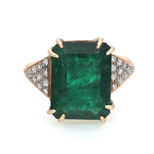 An image of a Rachel Koen women's cocktail ring with a large, central emerald-cut emerald set in a  18k yellow gold band. The emerald has a rich, deep green color and is held by four gold prongs. Flanking the central stone on both sides are triangular clusters of small, round-cut diamonds, creating a sparkling contrast. The ring is photographed from a top view at a close distance, showing off the facets of the emerald and the shine of the metal. The condition of the ring is pre owned. 