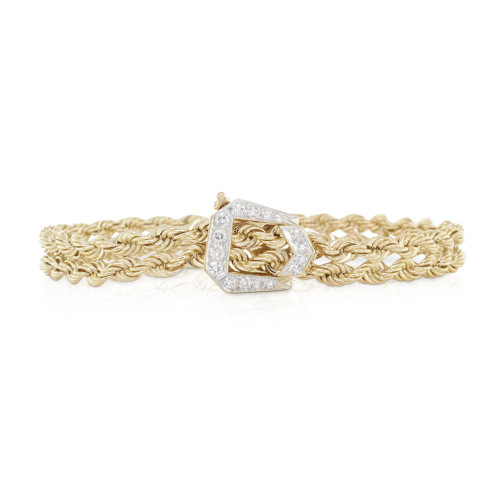 An image of a Rachel Koen women's bracelet with diamonds, featuring a yellow gold chain-link design and pave set diamond-encrusted clasp. The bracelet is positioned horizontally across the center of the frame with the clasp slightly off-center to the right, and the view is a close-up at eye level, showcasing the intricate details and the sparkle of the diamonds against the gold background.