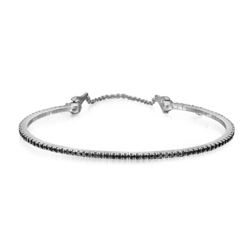 An image of a Messika women's Noir Black diamond 18k white gold bracelet, shown in a close frontal view against a white background. The bracelet is positioned in a slight curve, with the left side appearing closer to the viewer and the right side slightly receding, giving a sense of depth. The diamonds are encrusted along the entire circumference, sparkling against the bracelet's metallic setting. The clasp and adjustment elements are visible on both ends of the bracelet, designed with a sleek and elegant finish.