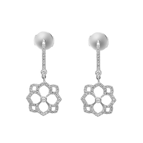 An image of a pair of Messika women's Eden Dormeuses drop earrings with diamonds, displayed against a white background. The earrings are shown in a frontal view, positioned symmetrically side by side, at a close-up distance that highlights their intricate design. Each earring features a sparkling diamond-studded drop connecting to a flower-shaped diamond-encrusted pendant, all set in a shiny white gold.